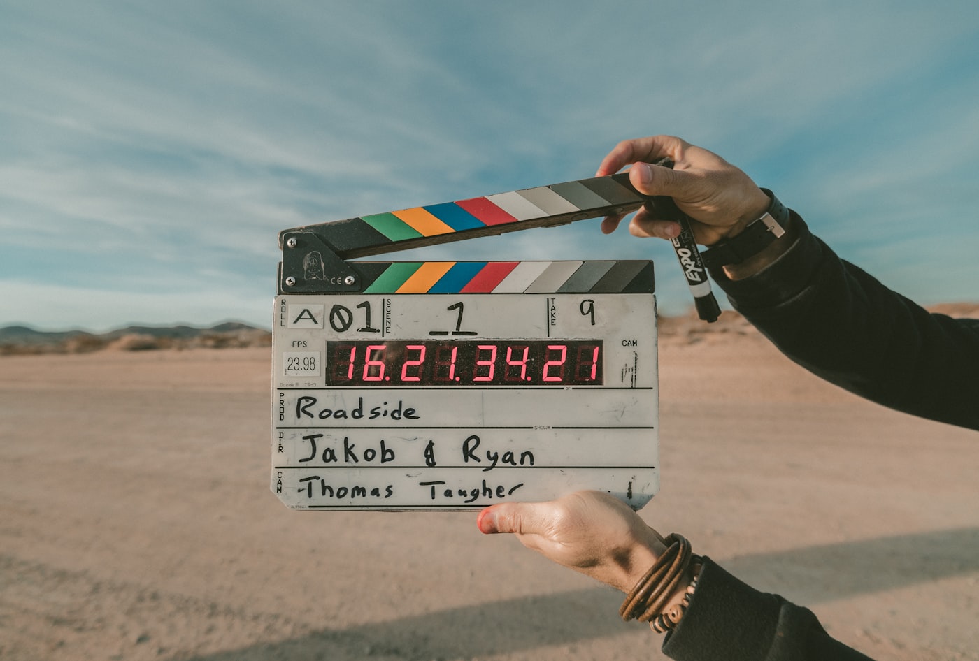 Film clapperboard held up on location