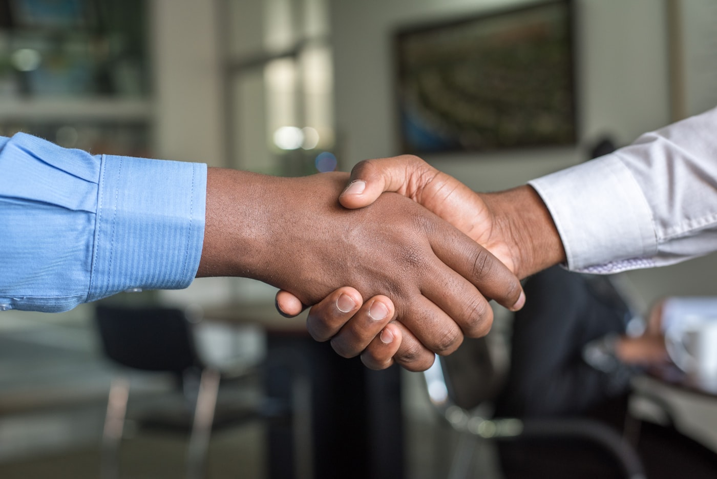 Two people shaking hands on an agreement